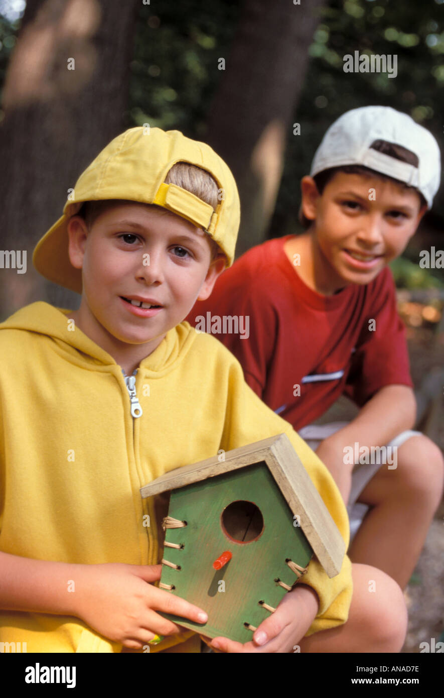 Boys with birdcage Stock Photo Alamy