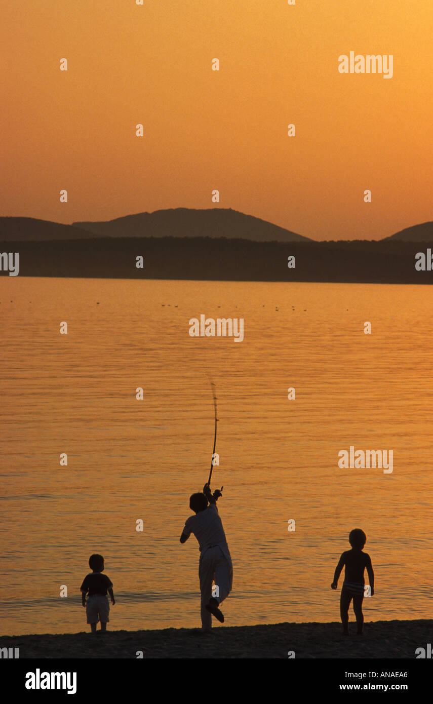 Silhouette father son fishing sunset hi-res stock photography and ...