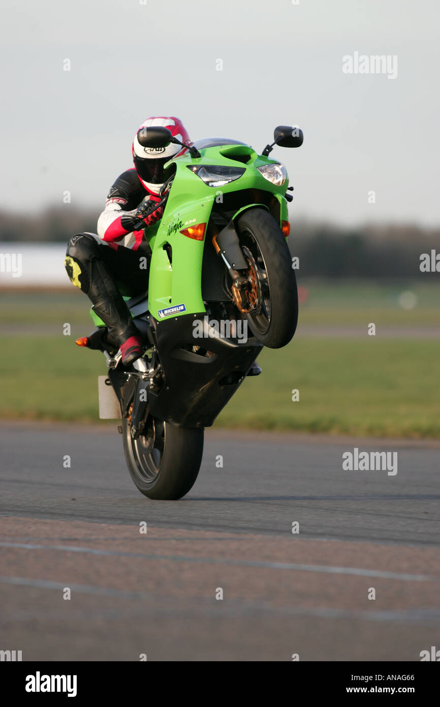 Motorcycles doing stunts including wheelies and jesus christs and burnouts Stock Photo