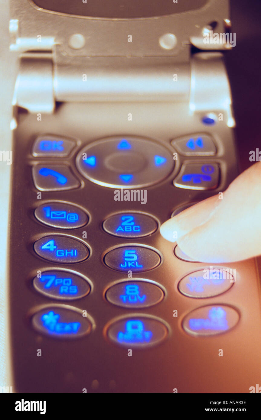 Finger pushing cell phone numbers Stock Photo - Alamy
