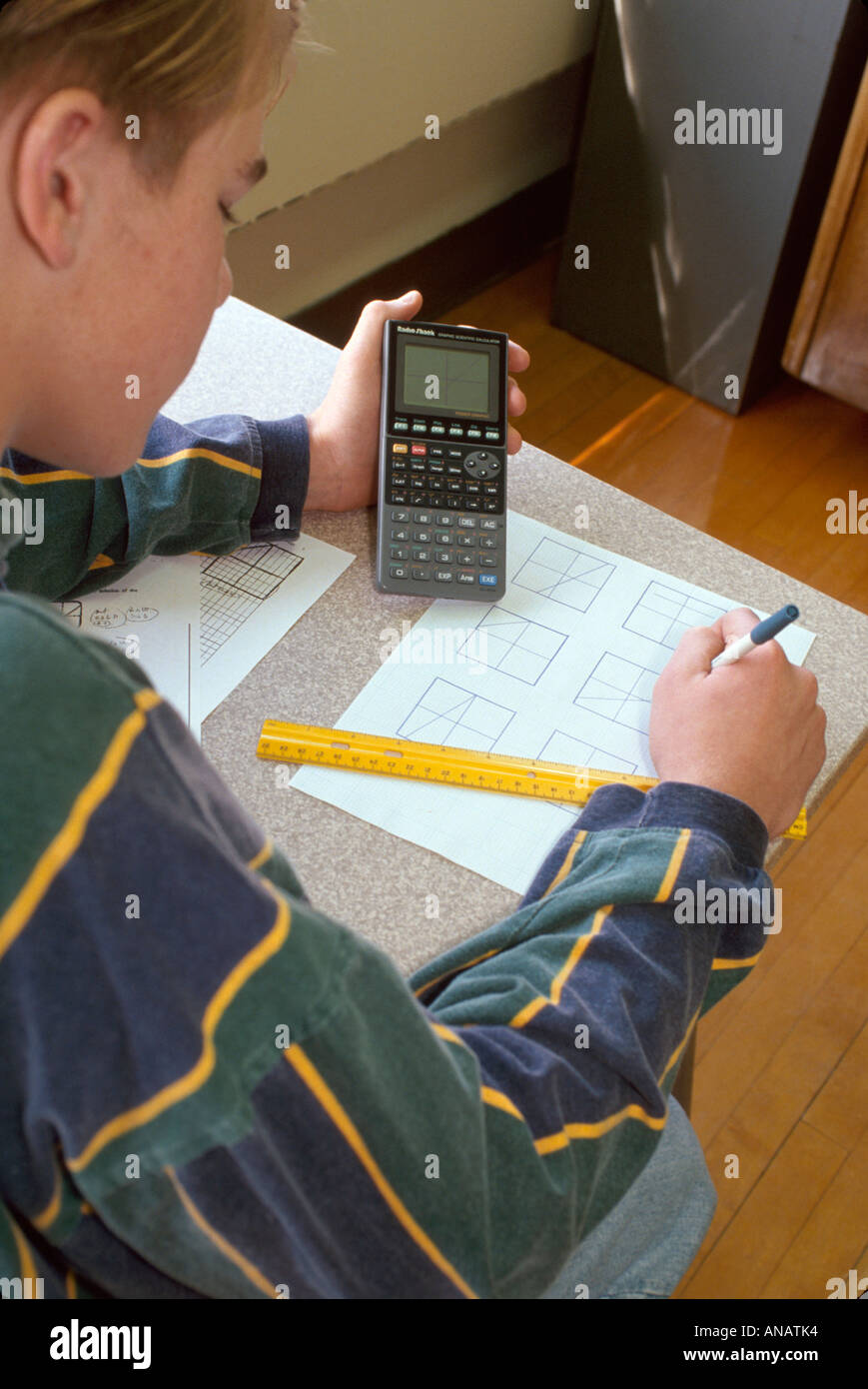 New Jersey Haledon,boy male teen teenager desk,student school,using graphing calculator math classroom class taking test exam Stock Photo