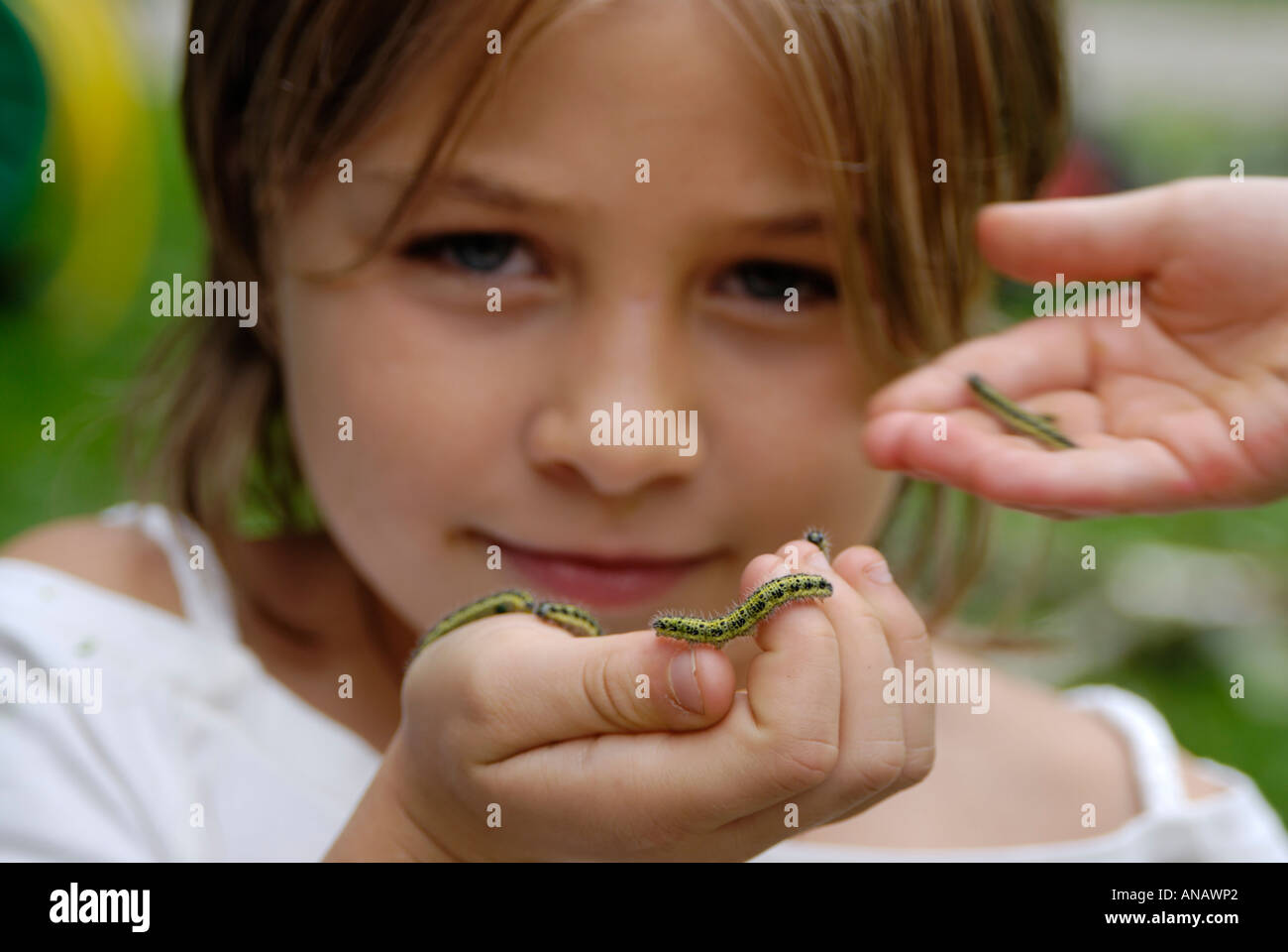 Child with a caterpillar exploring the nature nature games Stock Photo