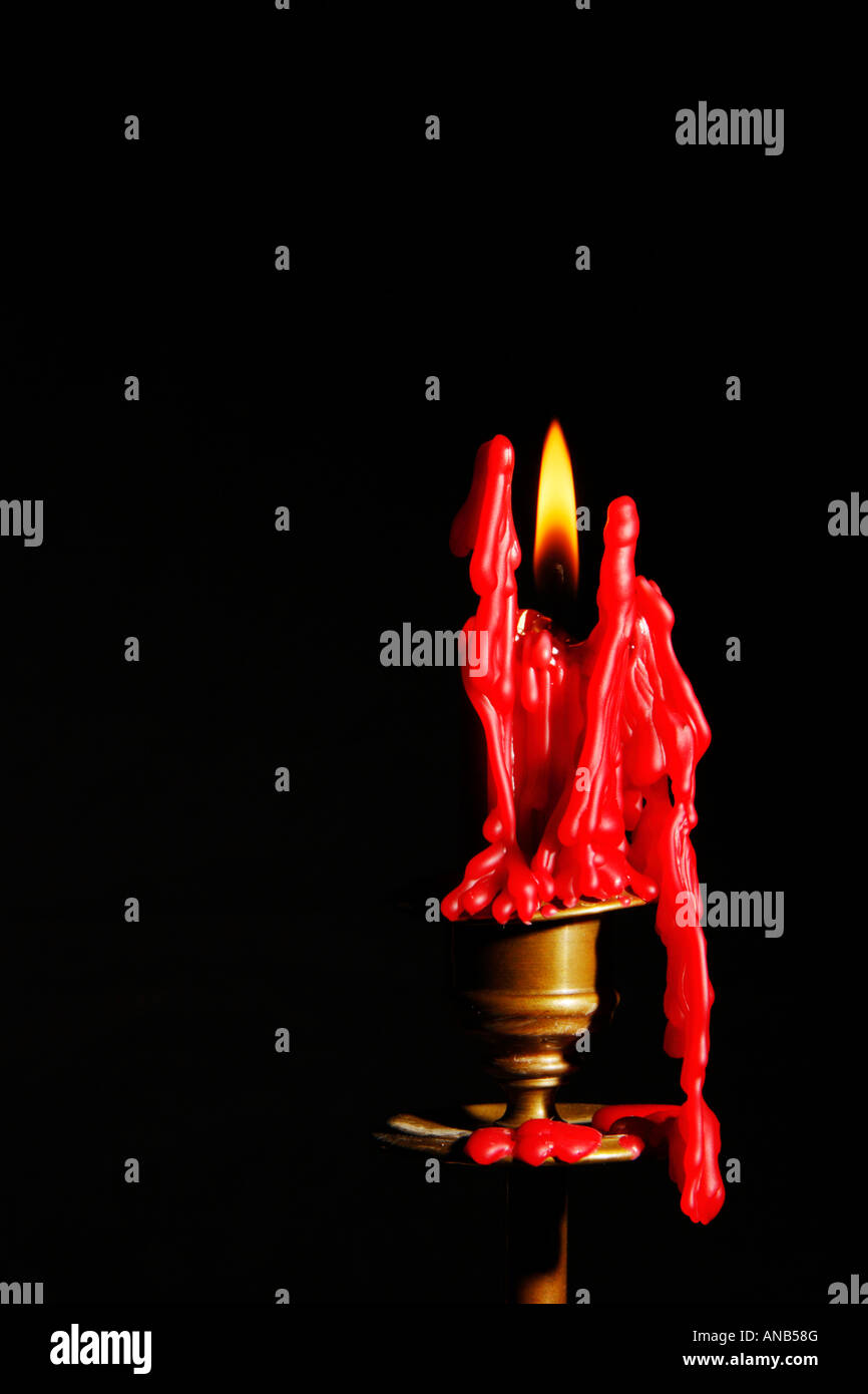 Spooky red candle lit in the darkness Stock Photo Alamy