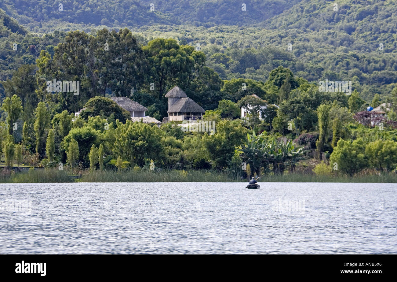 GUATEMALA LAKE ATITLAN Indigenous Tzutujil fisherman in a tiny cayuco boat Stock Photo