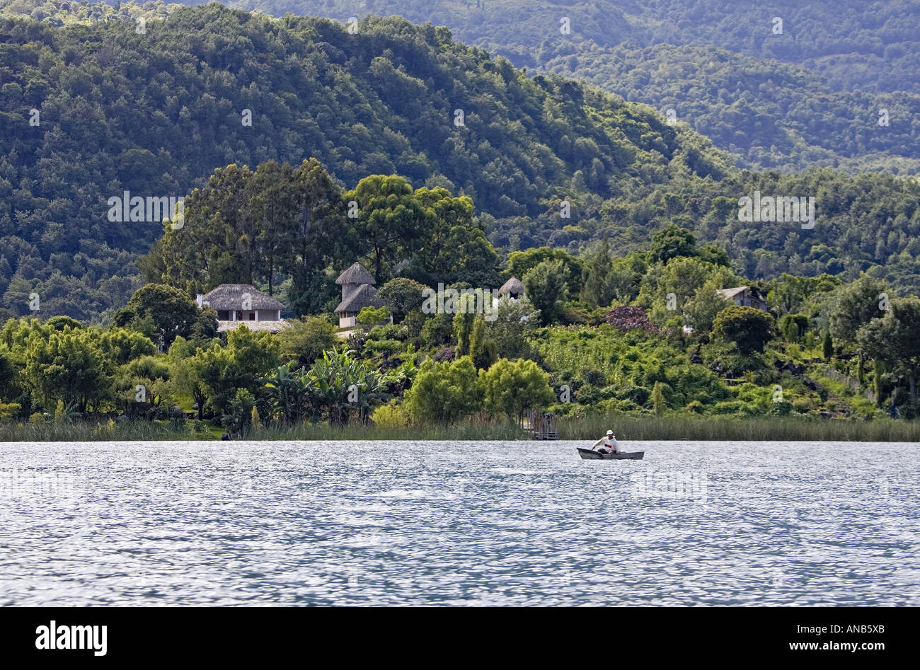 GUATEMALA LAKE ATITLAN Indigenous Tzutujil fisherman in a tiny cayuco boat Stock Photo