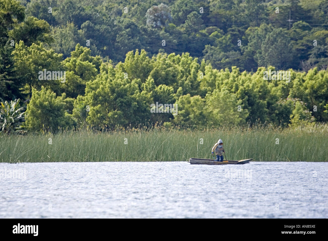 GUATEMALA LAKE ATITLAN Indigenous Tzutujil fisherman in a tiny cayuco boat Stock Photo