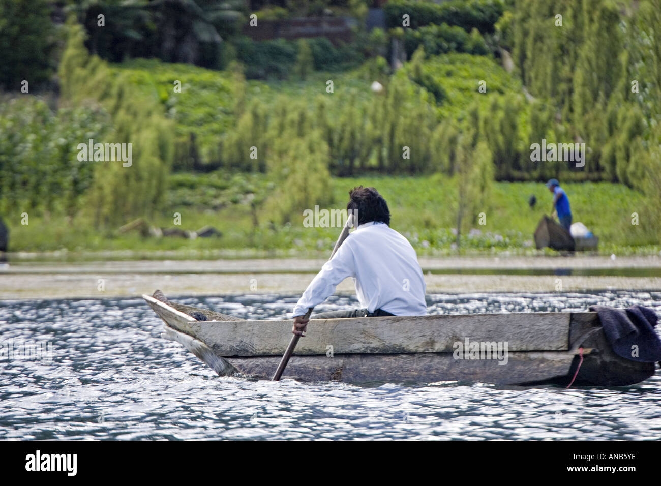 GUATEMALA LAKE ATITLAN Indigenous Tzutujil fisherman in a tiny cayuco boat Stock Photo