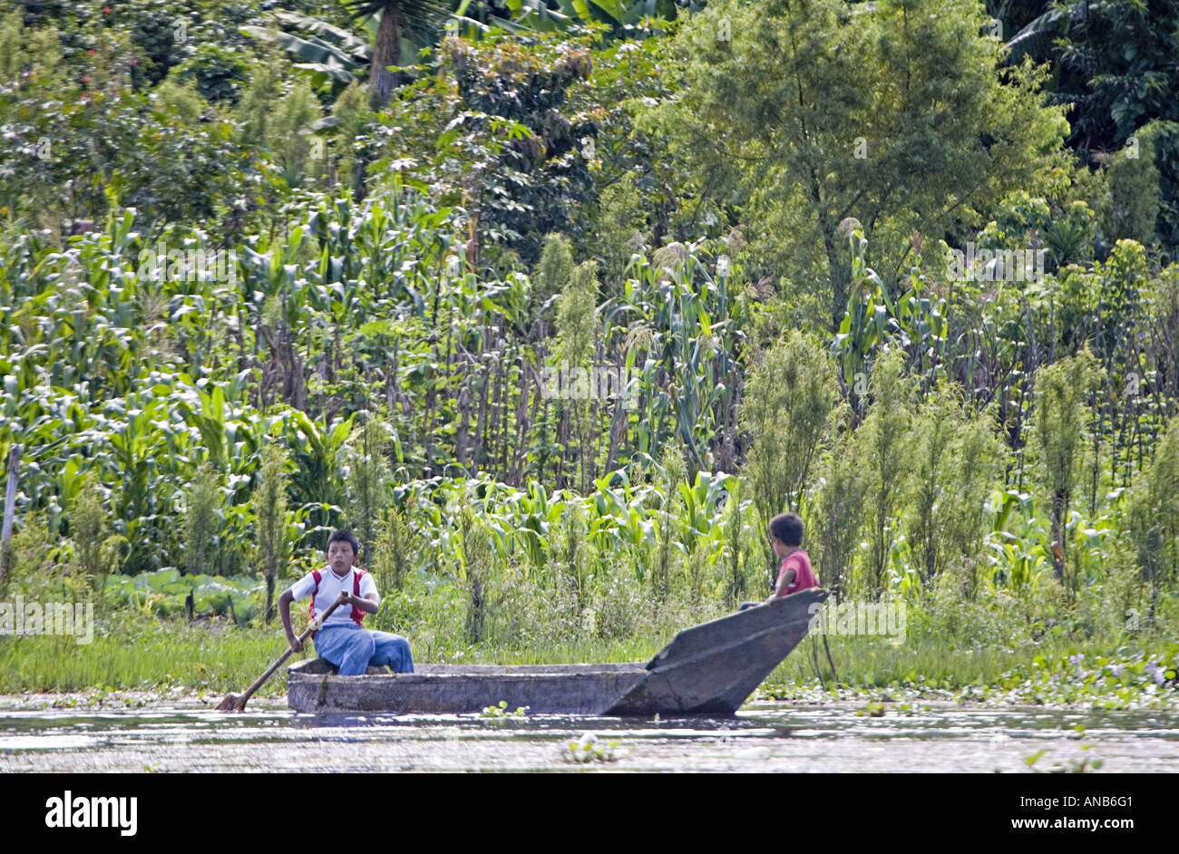 GUATEMALA LAKE ATITLAN Indigenous Tzutujil brothers in a tiny cayuco boat Stock Photo