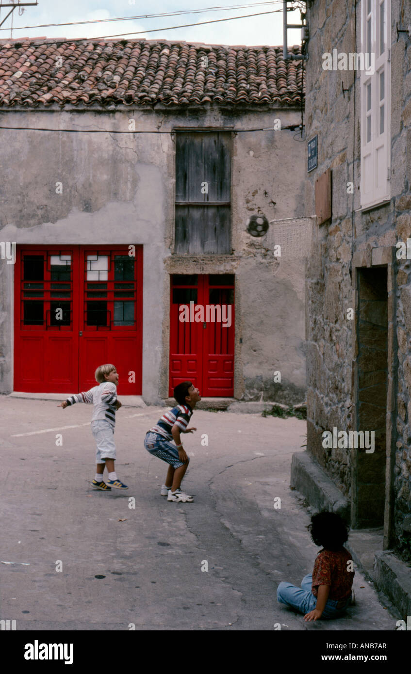 Children playing in a side street in the small fishing town of Camarinas Galicia North West Spain Stock Photo