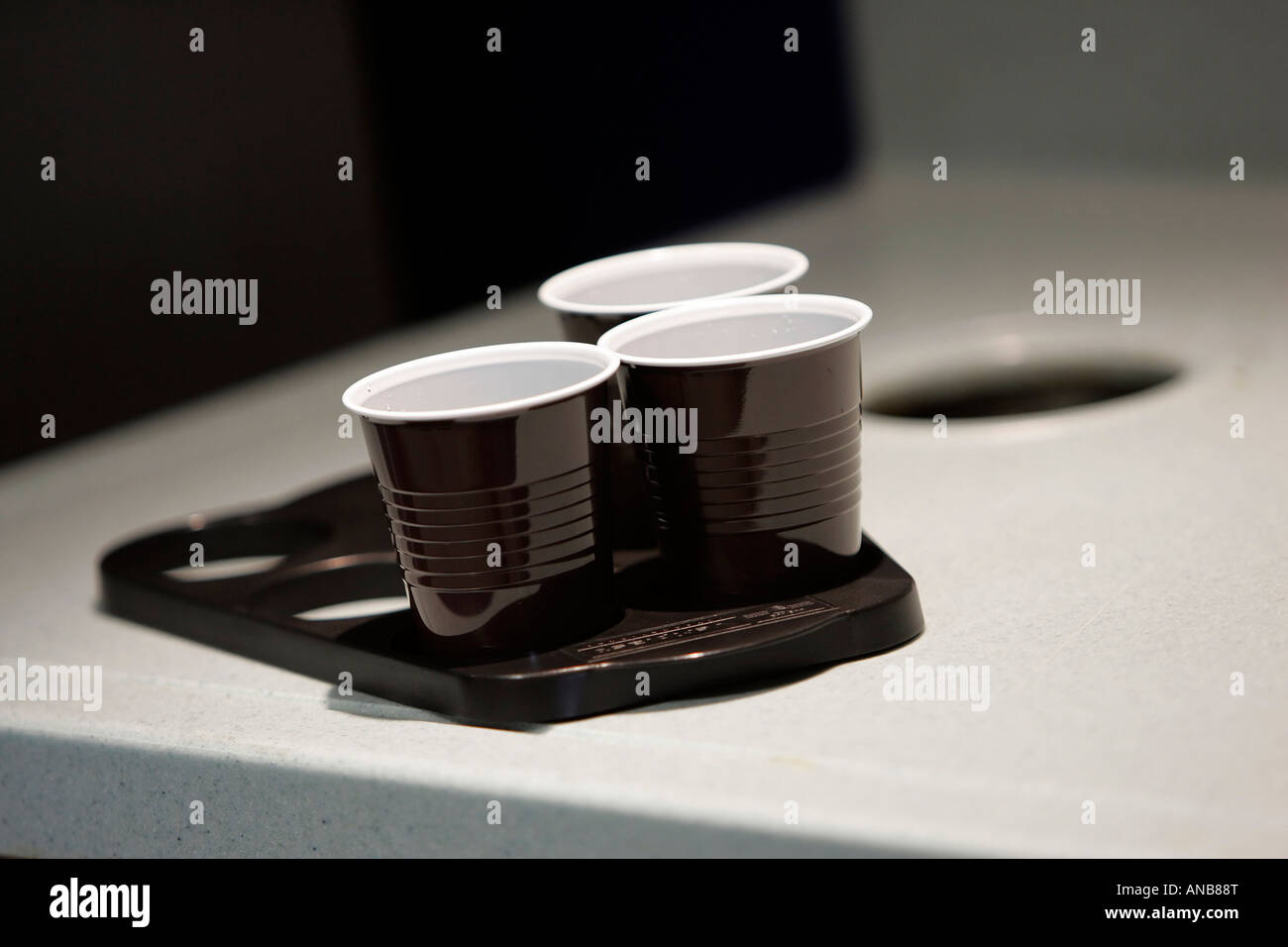 THREE DISPOSABLE CUPS AND TRAY IN AN OFFICE. Stock Photo