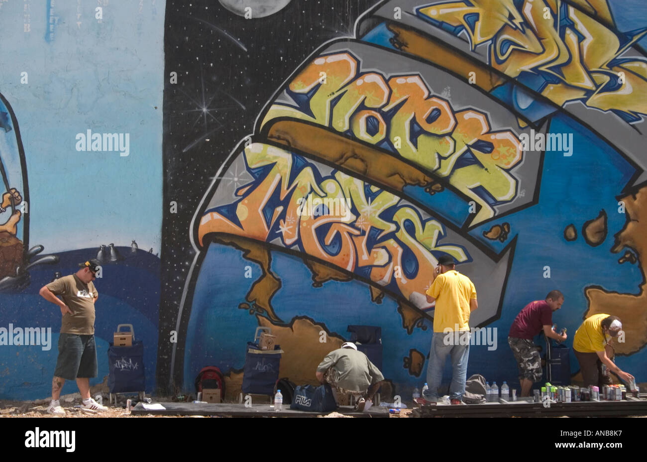 Graffiti artists painting wall Stock Photo