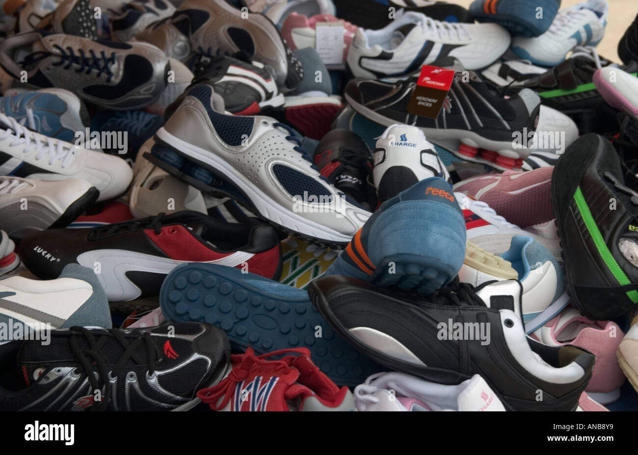 Pile of mixed shoes on market stall Stock Photo Alamy