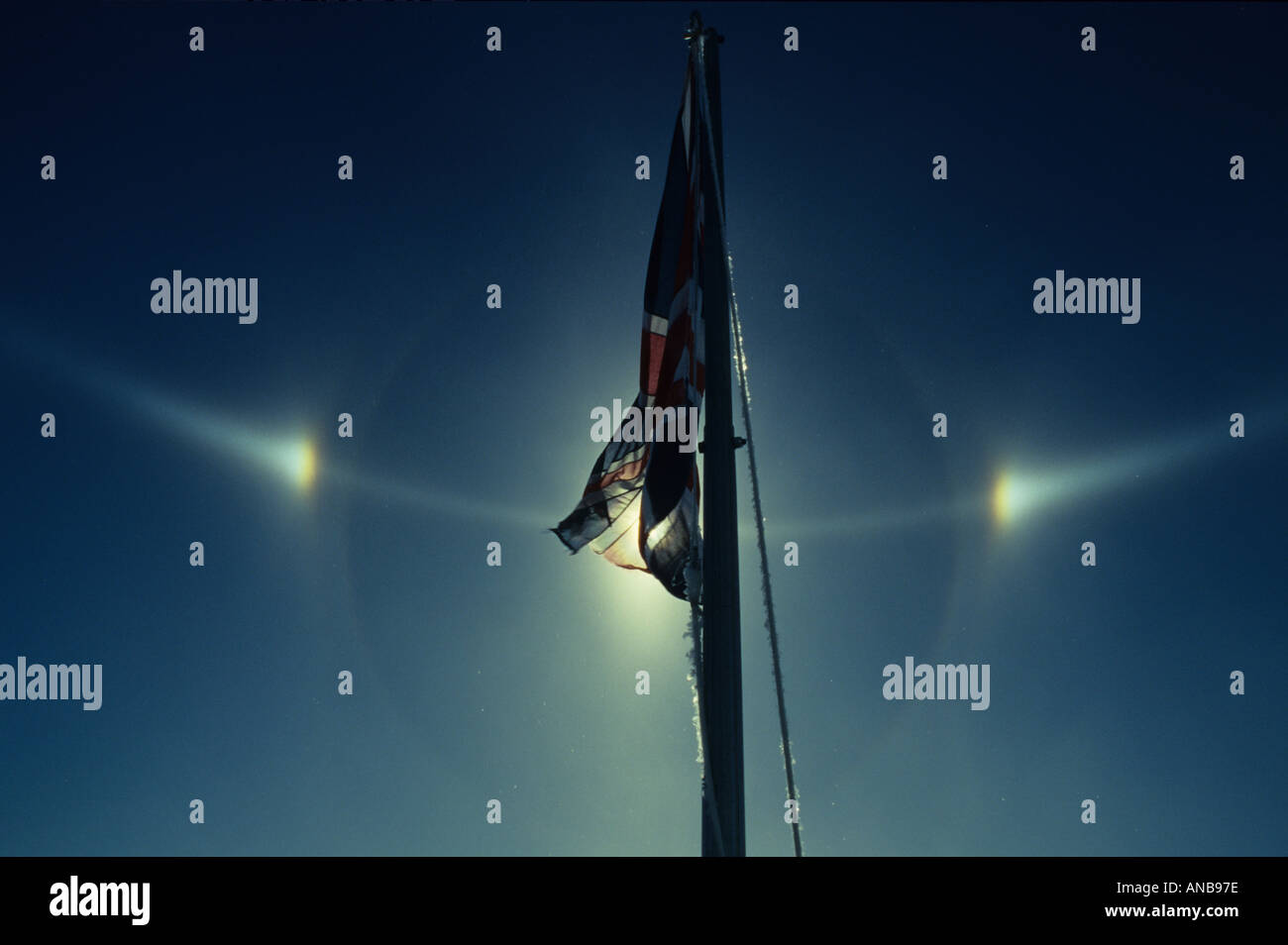Sundogs behind British flag flying in Antarctica Stock Photo
