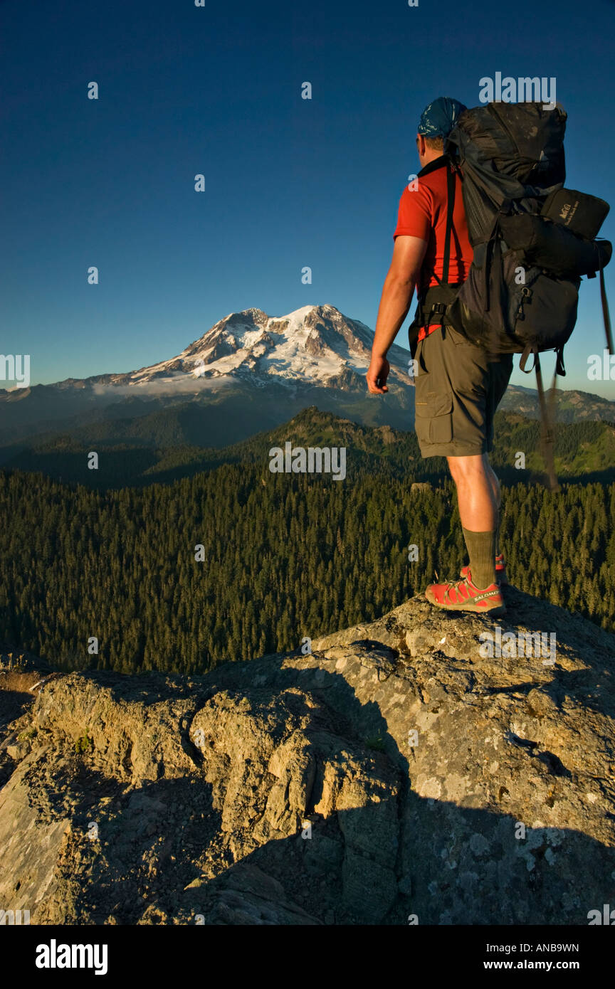 Backpacker and Mt Rainier at sundown Stock Photo - Alamy