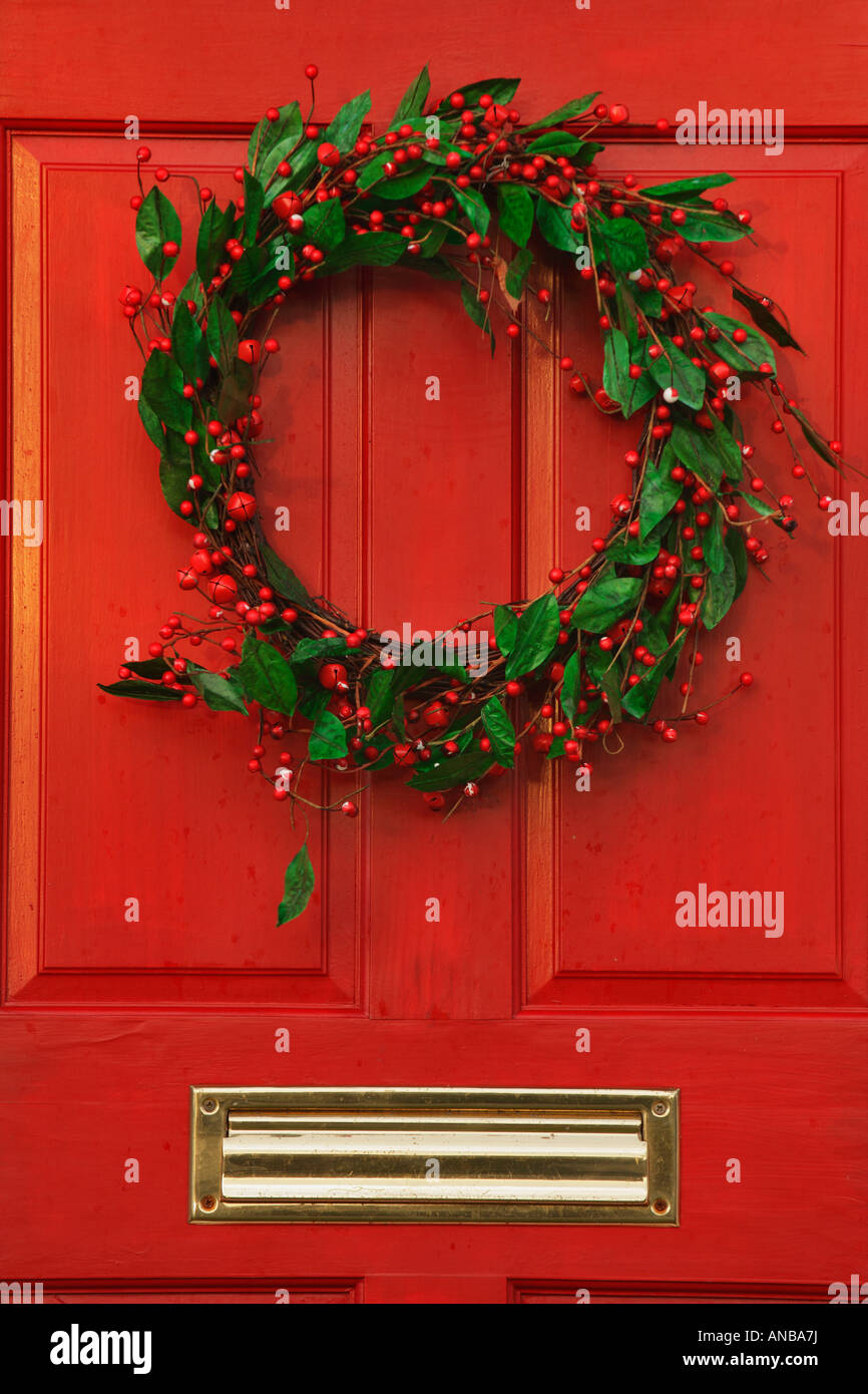Christmas holly wreath on distinctive red door of residential home Victoria British Columbia Canada Stock Photo