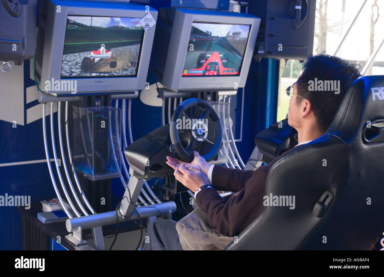 asian man playing computer simulation game at Cebit 2004 tradeshow in Hannover Germany Stock Photo