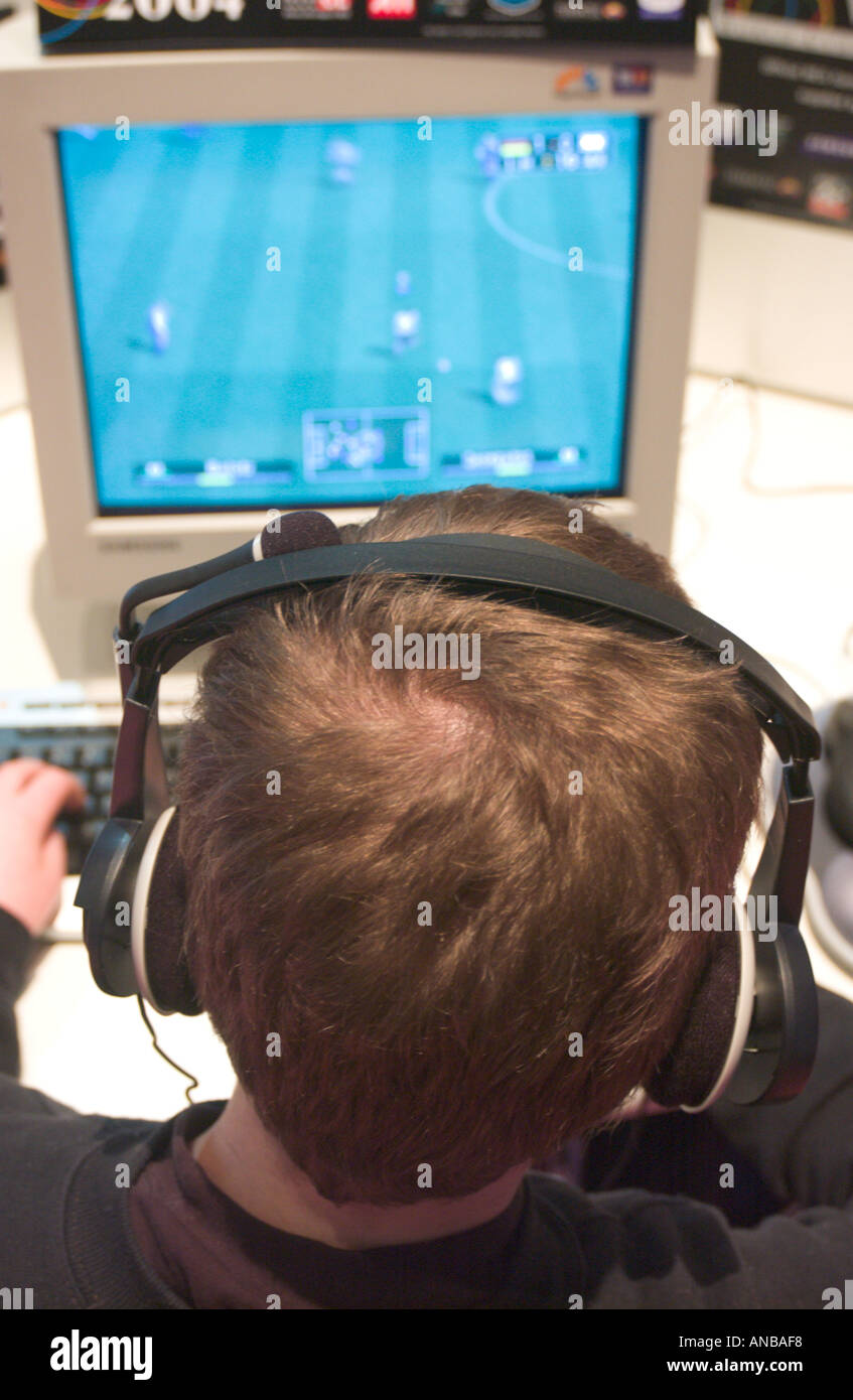 boy playing computer game at Cebit 2004 tradeshow in Hannover Germany Stock Photo