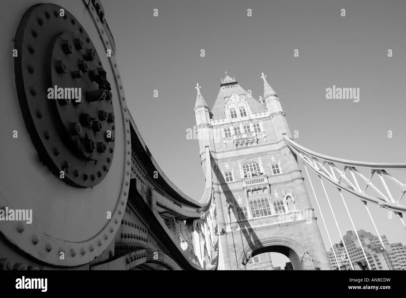 suspension arms of Tower bridge shot in Black and white with on of the supporting towers visible in the background Stock Photo