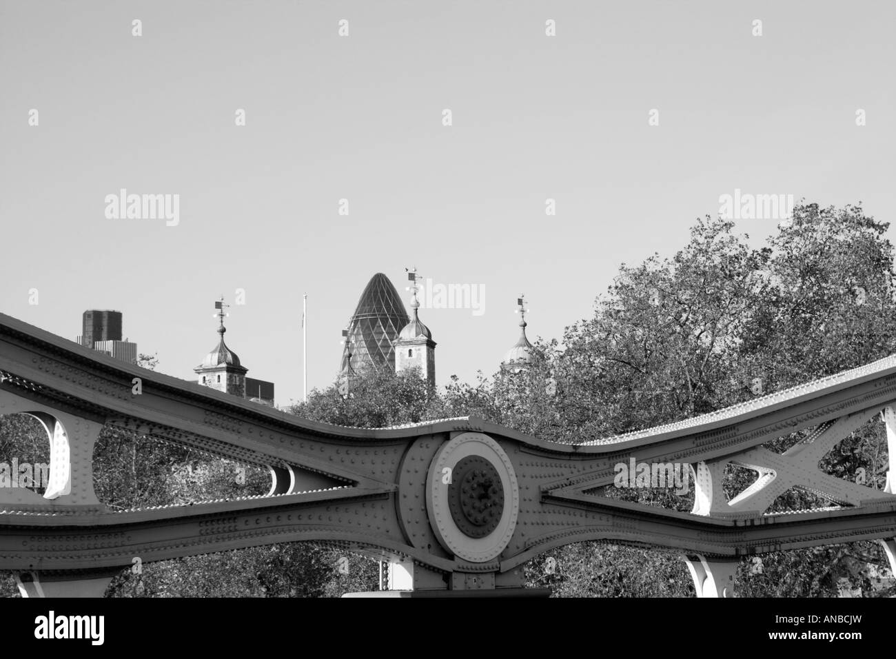 Part of the suspension arm of Tower bridge in Black and white with the Swiss Rea building gherkin and part of the Tower of Londo Stock Photo