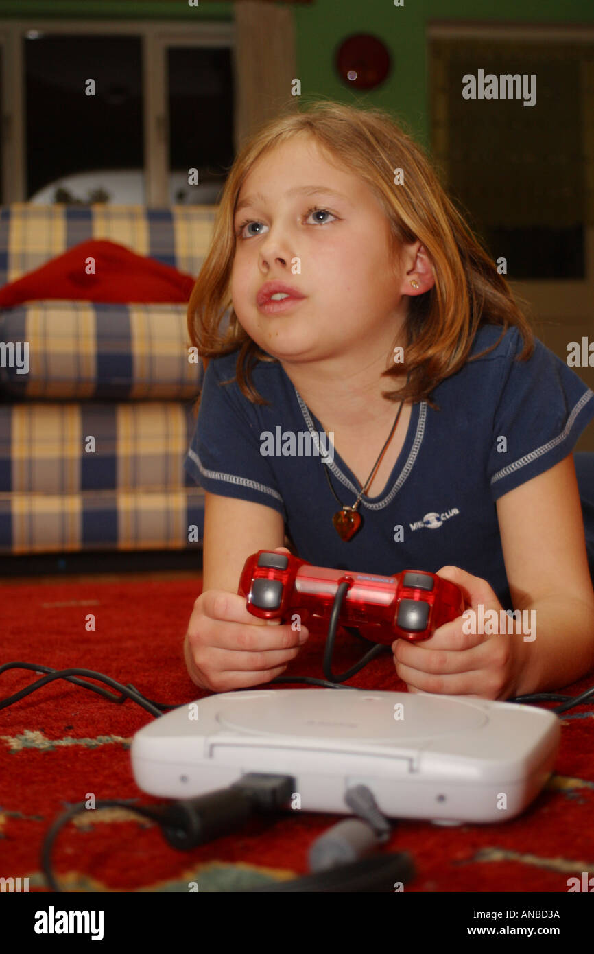 Young girl engrossed with playing her playstation computer game Stock Photo