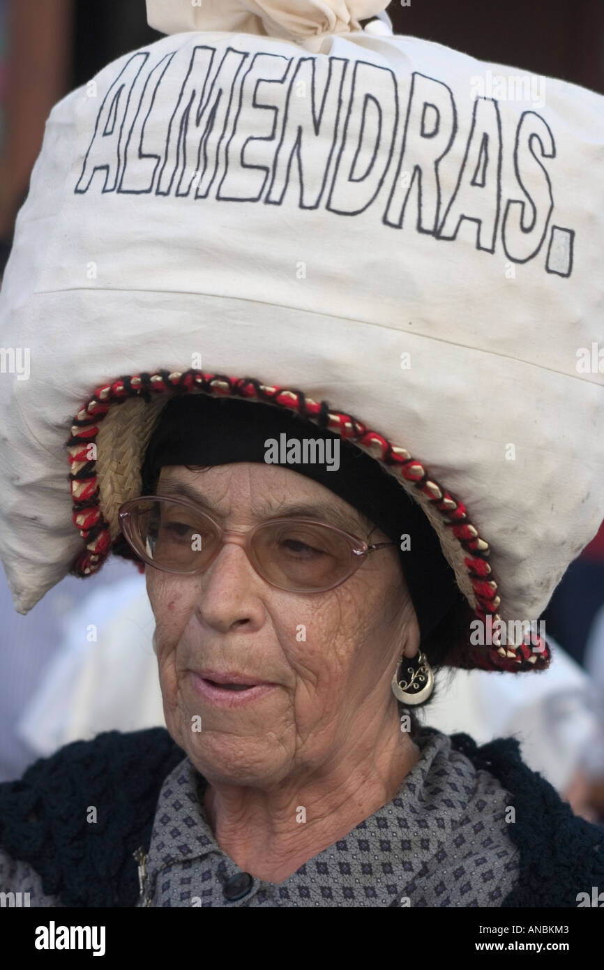 Spanish woman carrying sack of almonds on her head at Fiesta del Pino on Gran Canaria. Stock Photo