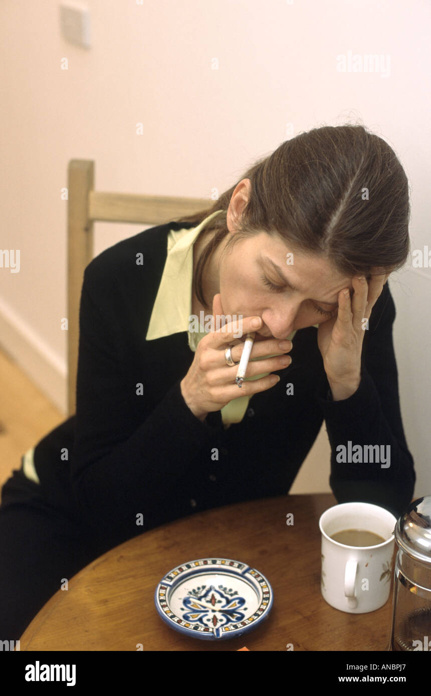 smoking cigarettes and drinking coffee woman smoking and drinking coffee Stock Photo