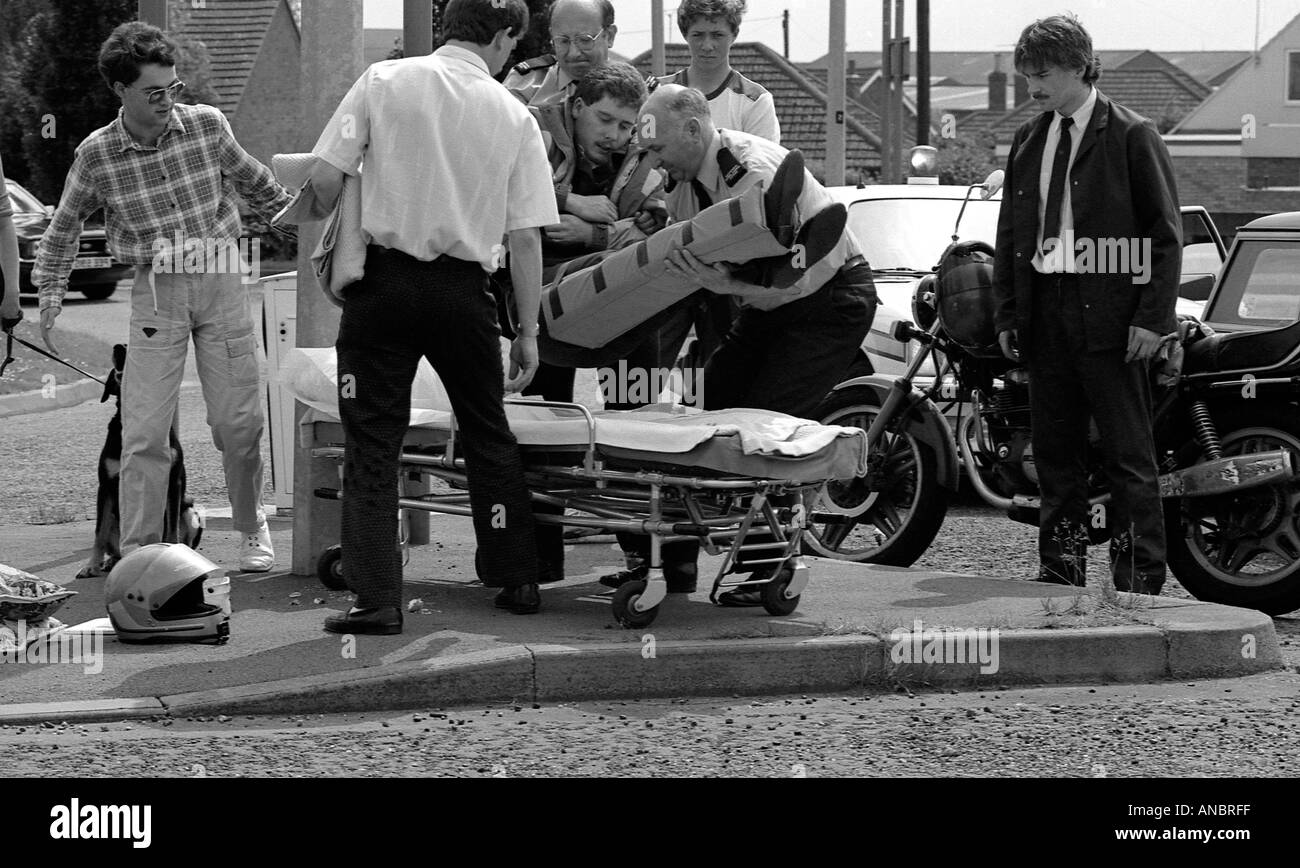 Road accident victim being placed on wheeled stretcher by paramedic