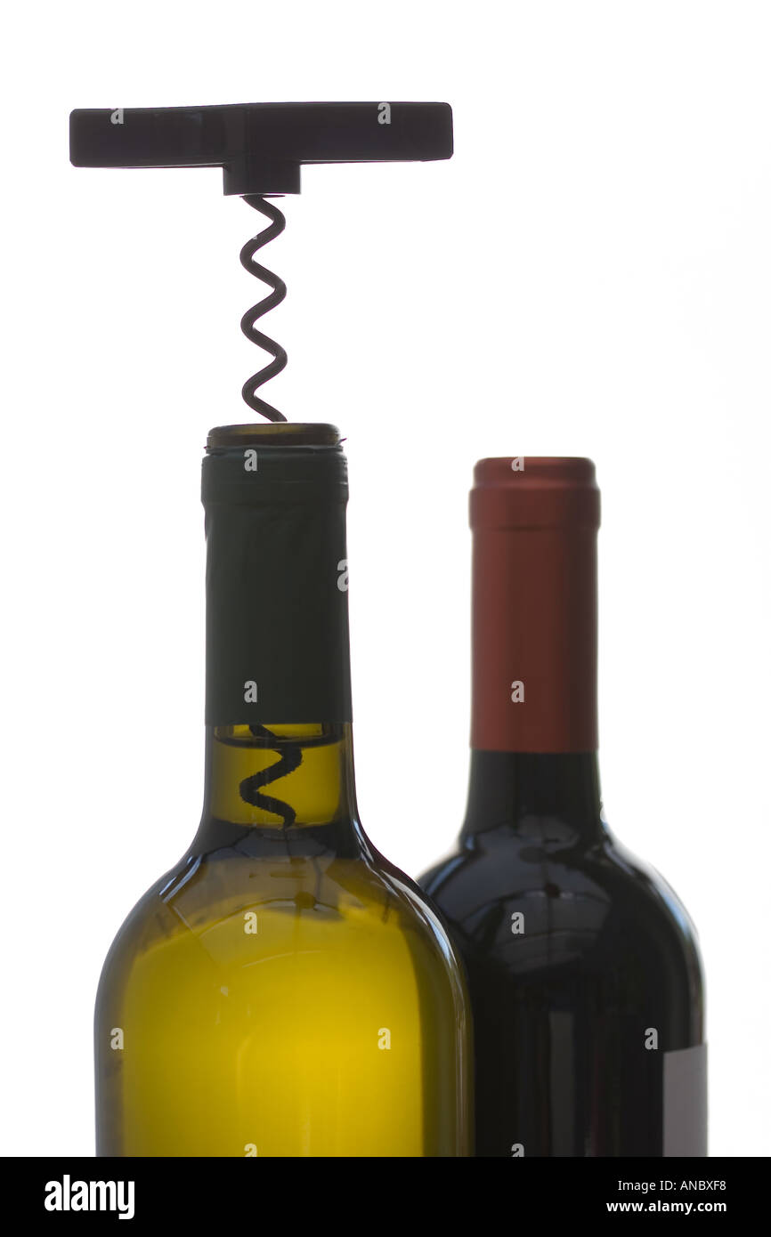 Red and White Wine Bottles with Corkscrew silhouetted Stock Photo