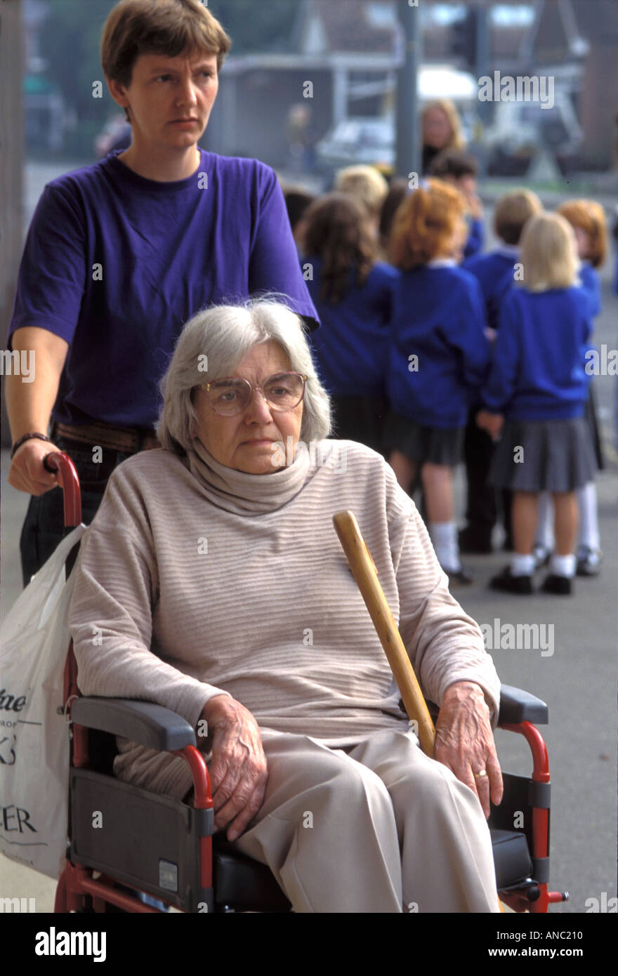 Elderly woman in her own home with a carer UK Stock Photo