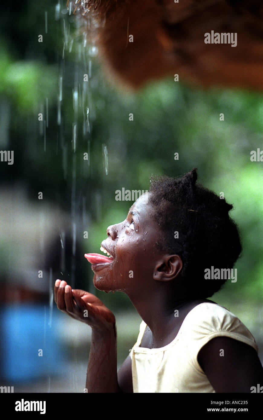 Child in remote Zambian Village collects drinking water from thatched