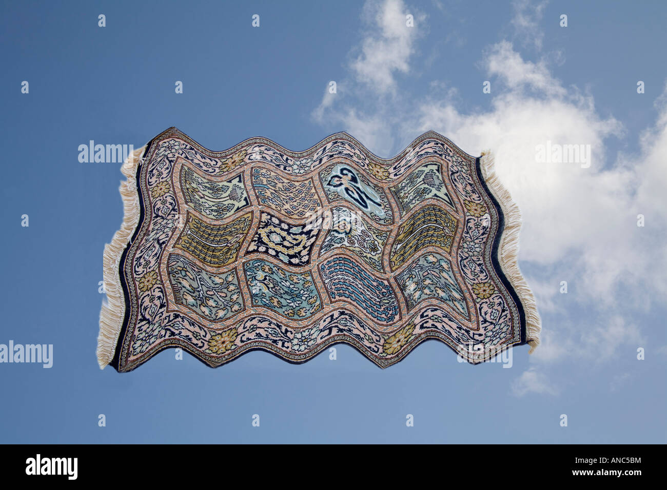 Studio Cut Out Close up Still Life A silk carpet flying across a blue sky Stock Photo