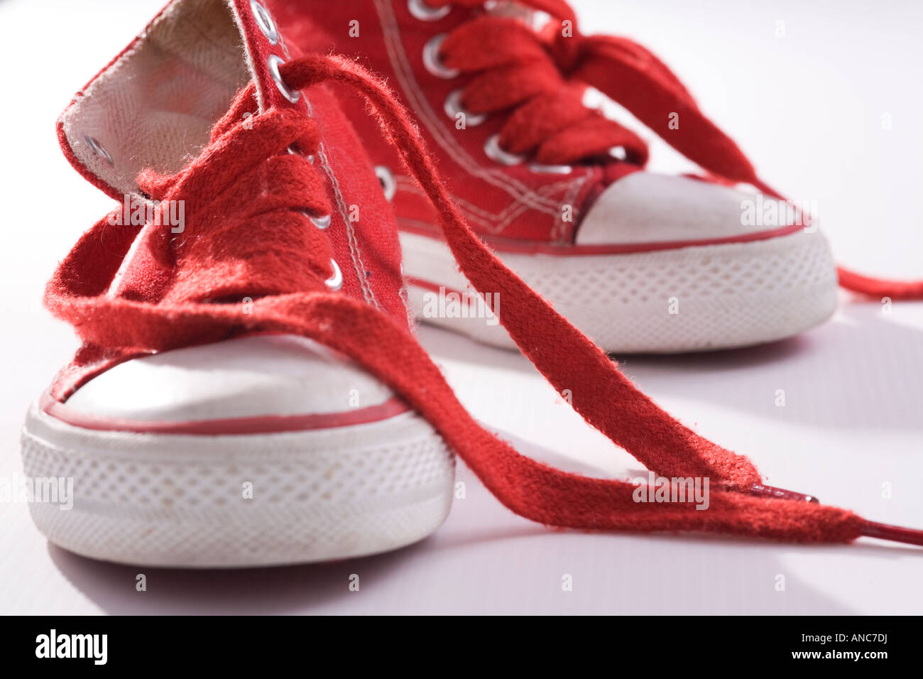 Red hi tops with loose laces Stock Photo