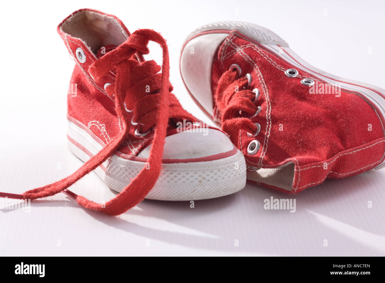 Red hi tops with loose laces Stock Photo