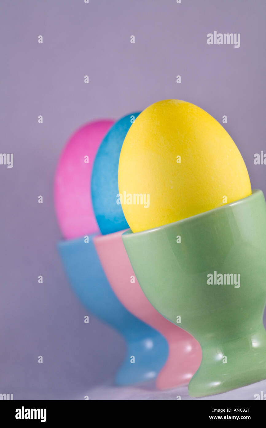 Three Easter eggs in egg cups lined up Stock Photo Alamy — free download