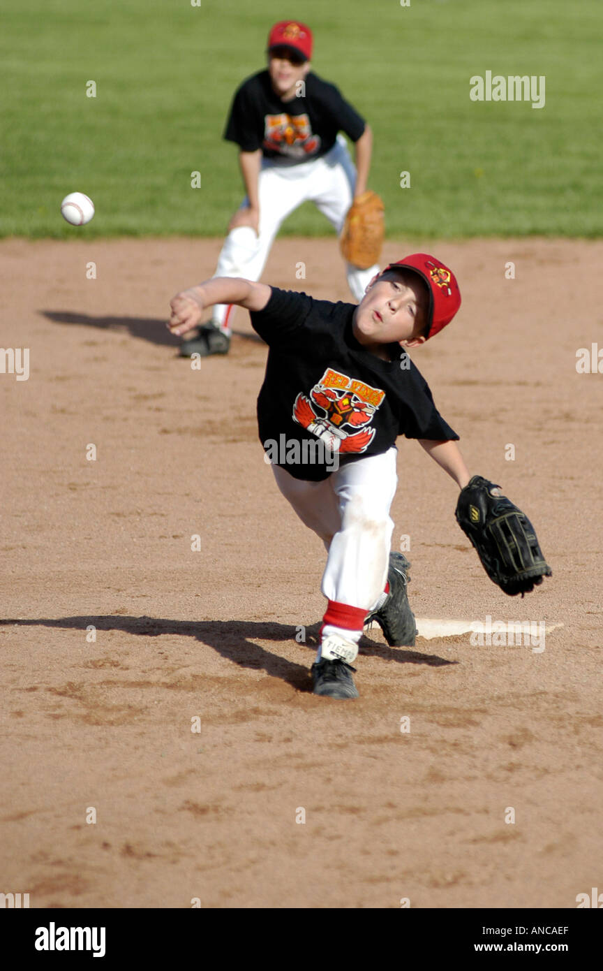 Little league Baseball Action Throwing pitching baseball ball Stock Photo