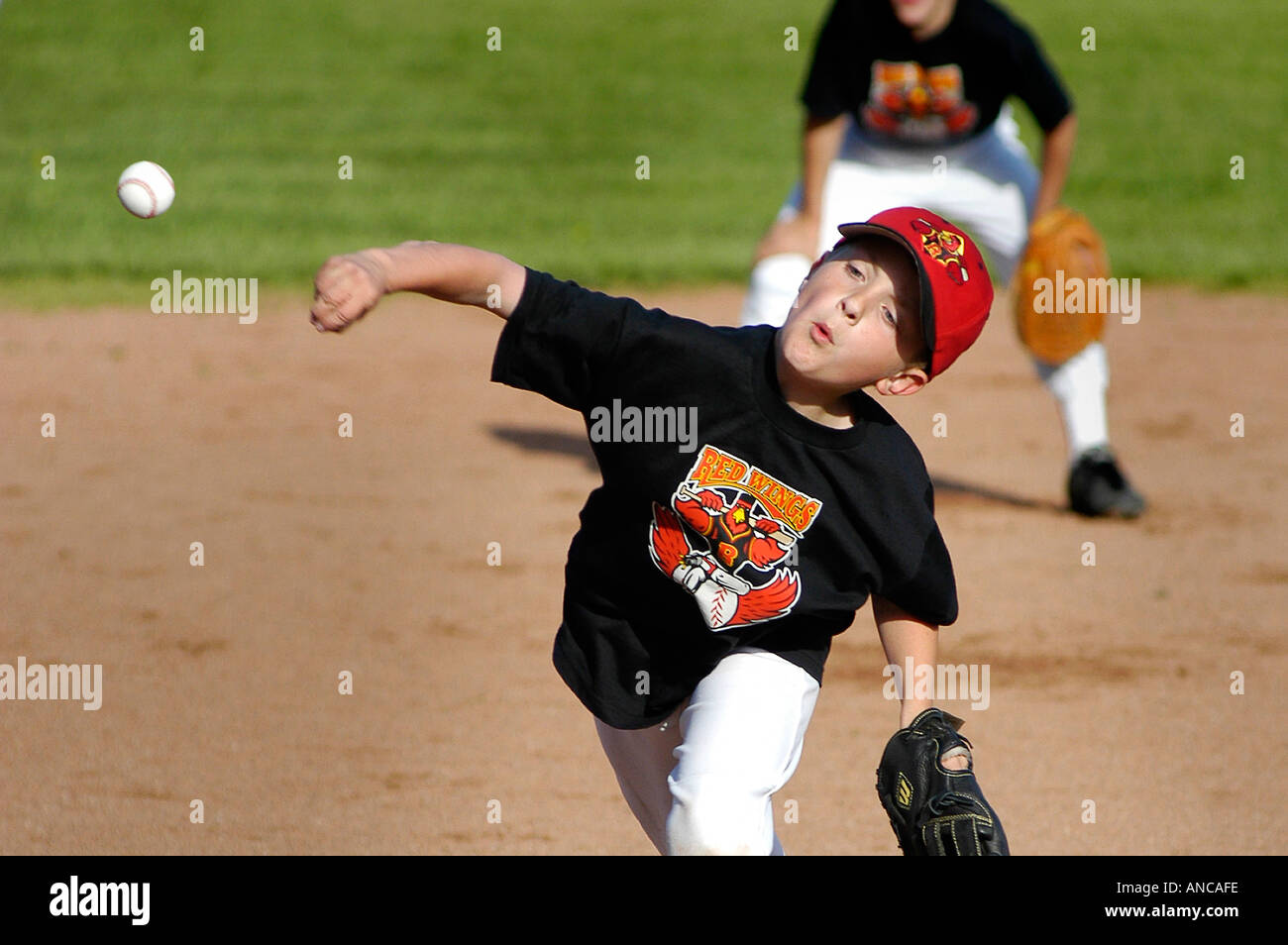 Little league Baseball Action Throwing Pitching baseball ball Stock Photo