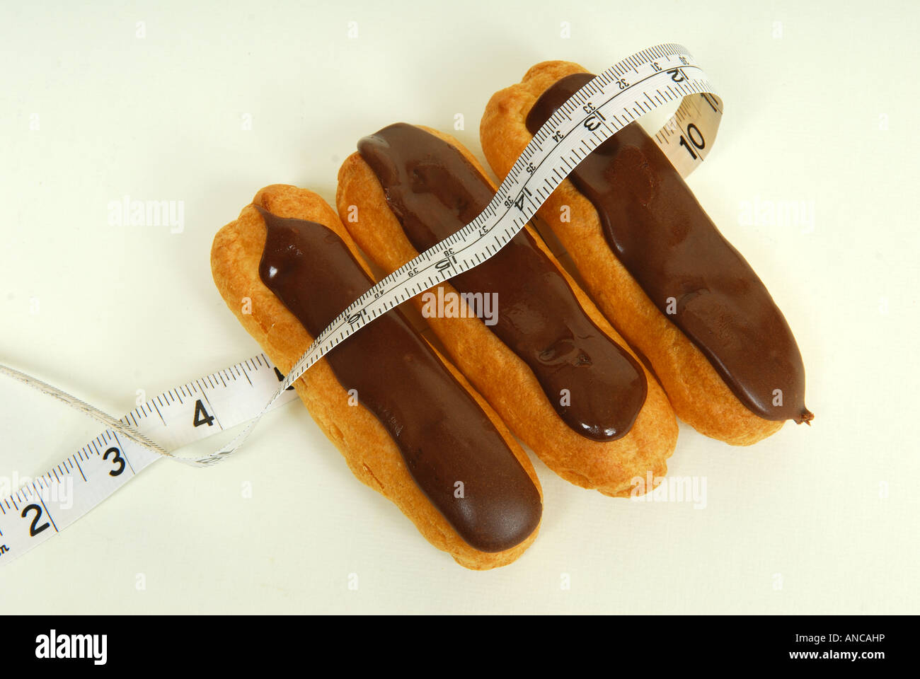 Eclair with tape measure. Stock Photo