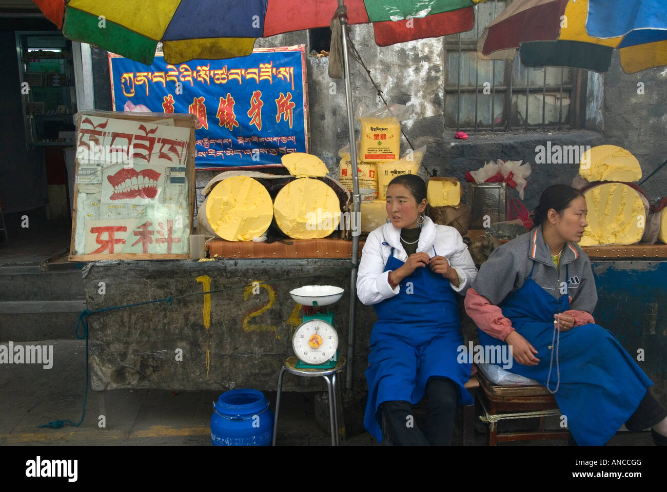 Tibetan girls selling Yak cheese from a roadside stall in the capital, Lhasa. Stock Photo