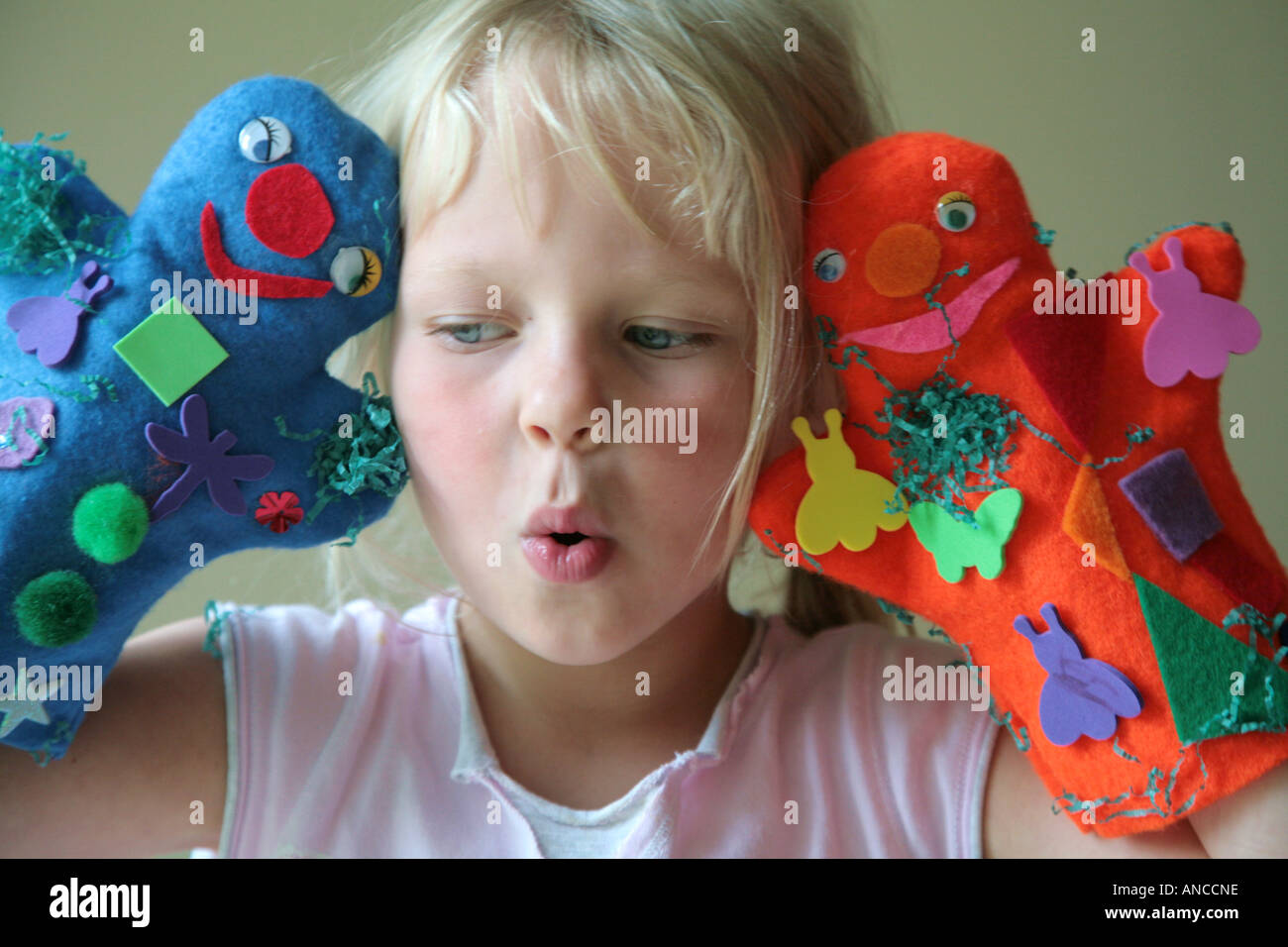 young girl playing with puppets Stock Photo