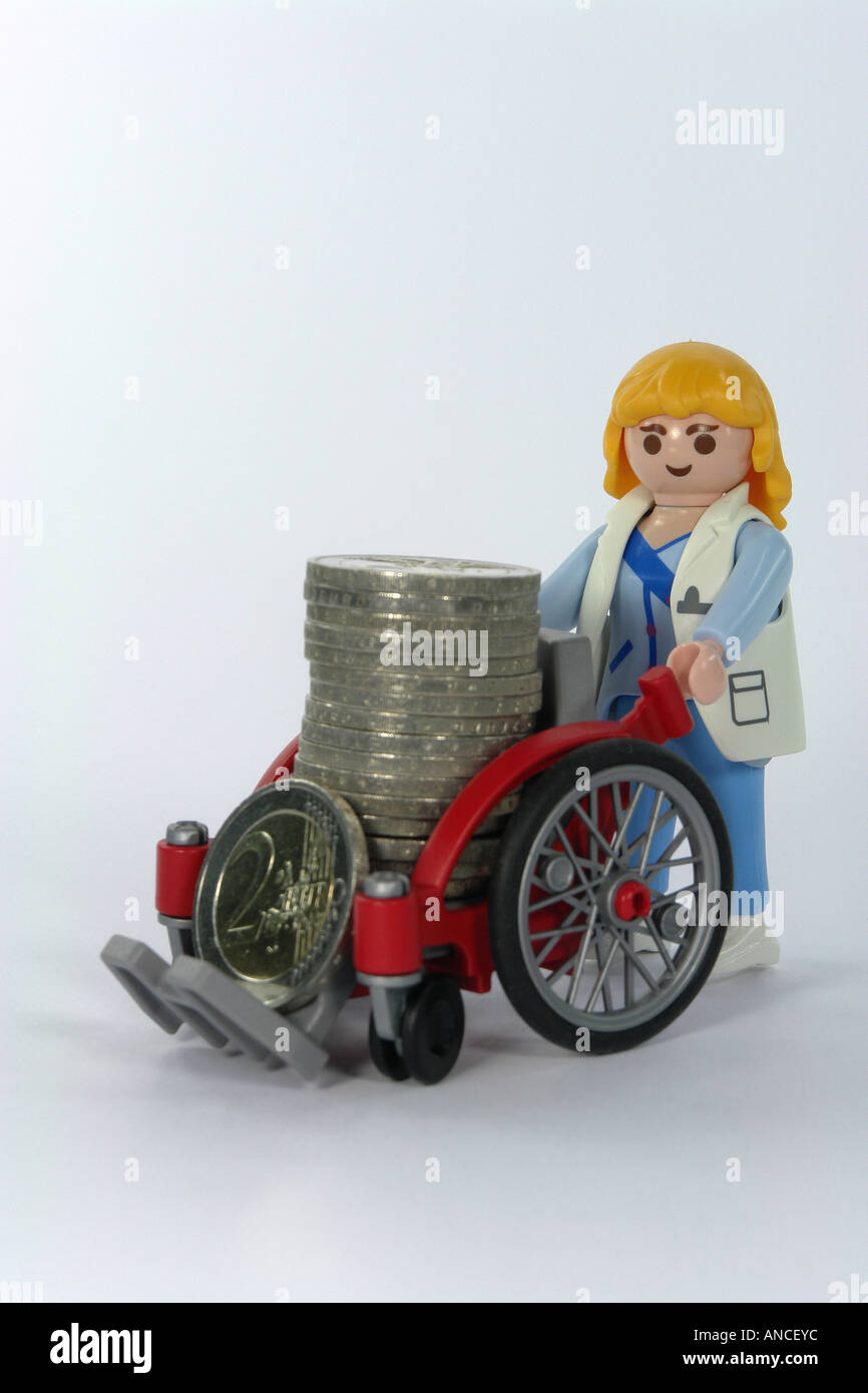 euro coins in the wheelchair as symbol for the sozial system Stock Photo
