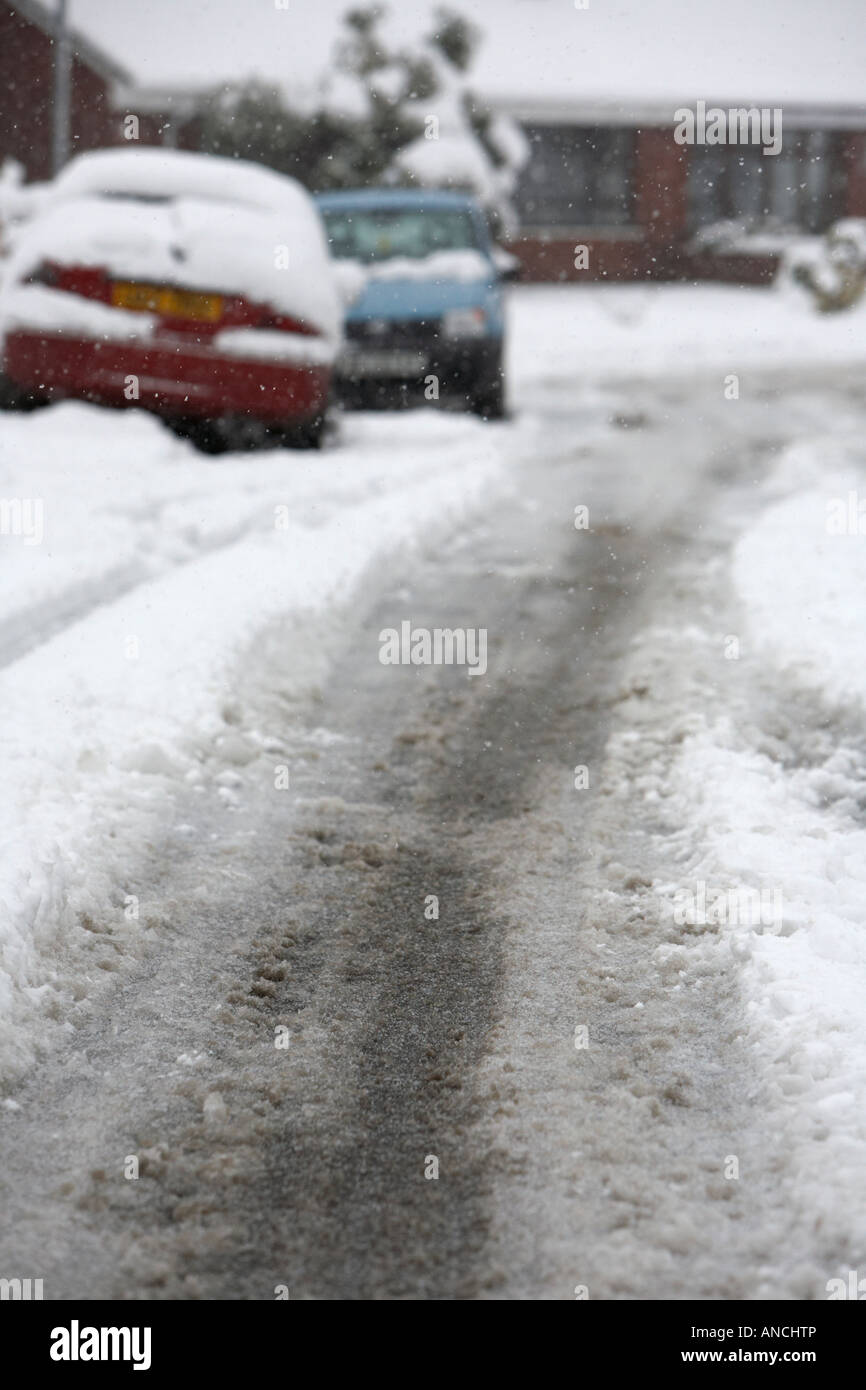 tyre tracks and car marks in the middle of the road of snow covered ...