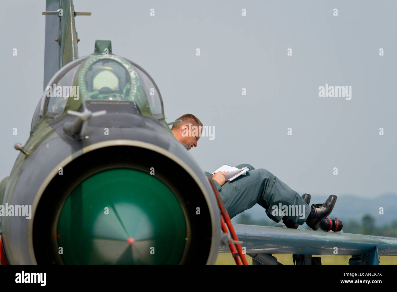 Croatian Air Force MiG-21 BISD fighter, Pleso AFB during 'open day' visit in 2007, pilot is writing notes while sitting on wing Stock Photo