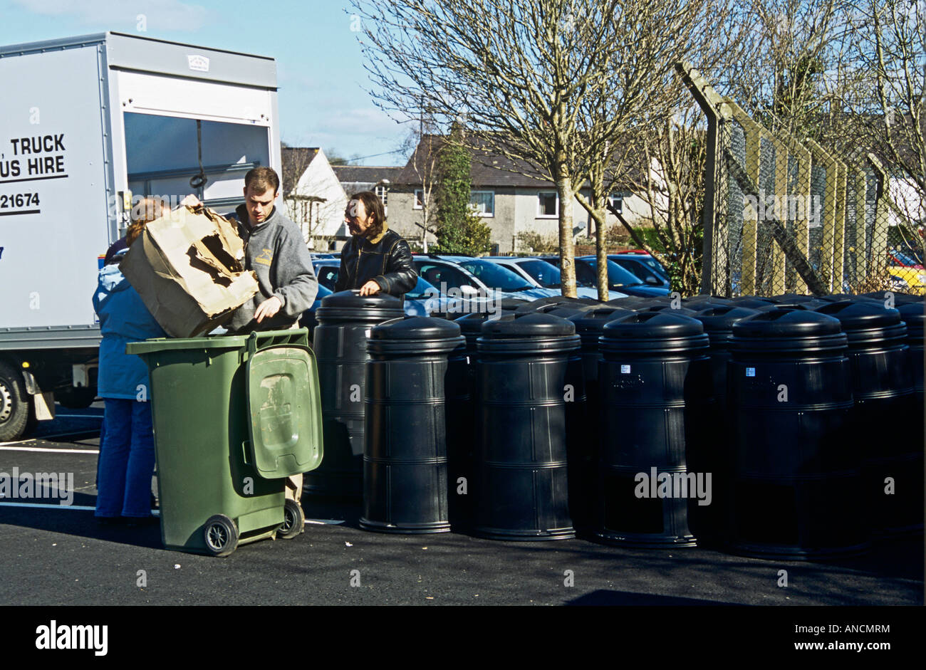 North Wales UK Two men wait to hand out black compost bins provided