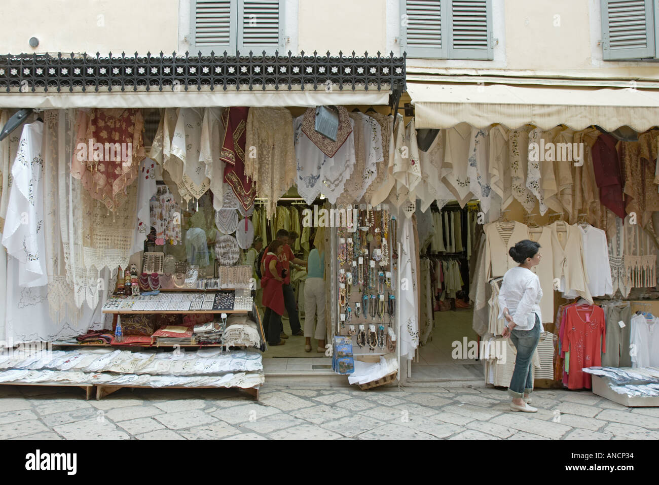 Small shop selling tablecloth and souvenirs in Kerkyra old town. Corfu island, Greece. Stock Photo