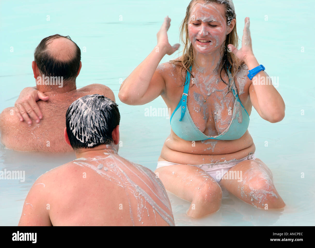 Visitors Enjoying a Silica Rub at the Blue Lagoon Spa Iceland Stock Photo