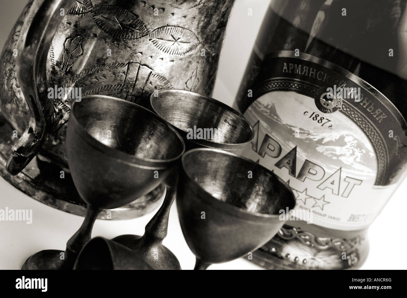 Bottle of famous Armenian cognac ARARAT and vintage silverware close up Stock Photo