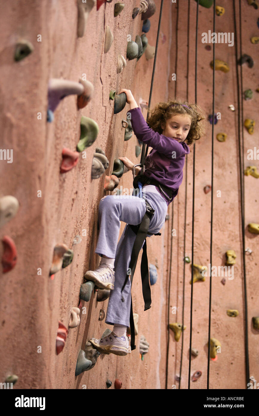 Child Rock Climbing at Indoor Facility Stock Photo