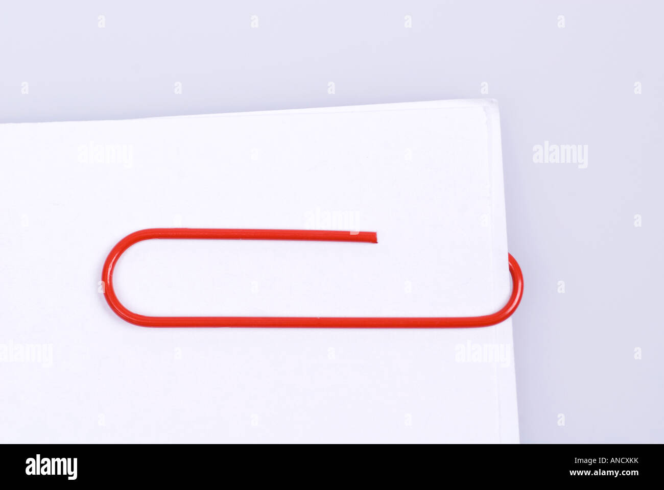 Red paperclip and papers Stock Photo