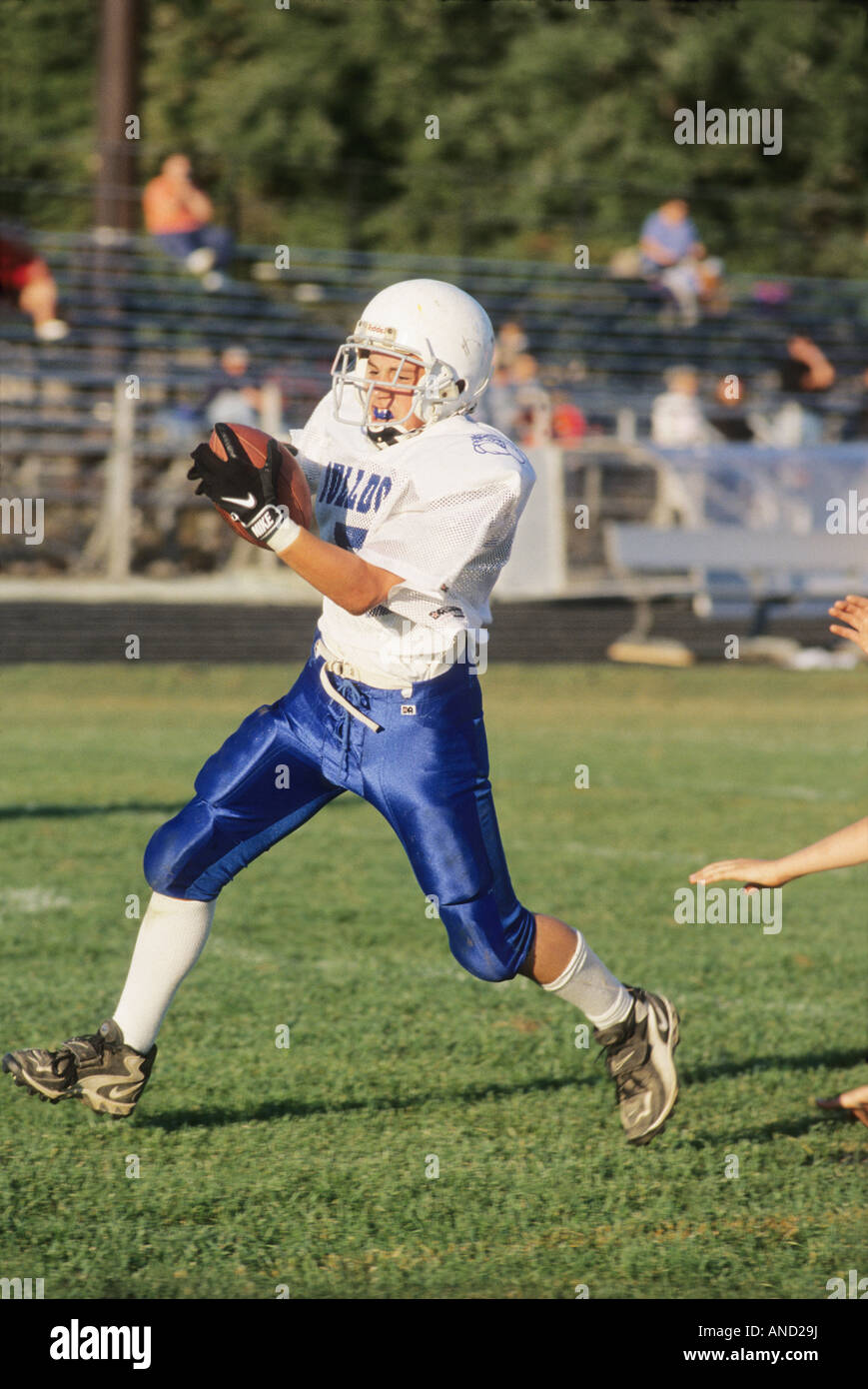 Junior high school football player runs with ball during game American Football Ohio USA sports safety equipment Stock Photo