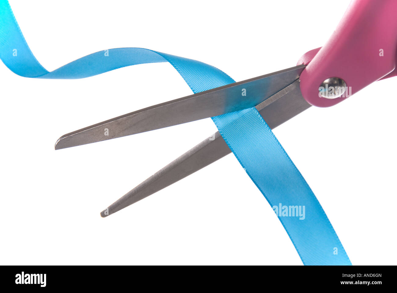 Close up image of an isolated pair of scissors cutting into blue ribbon Stock Photo